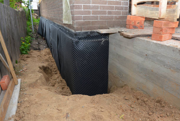 SJ Waterproofing Pros technician performing targeted Wet Basement Repair assessment in Spring Lake, MI